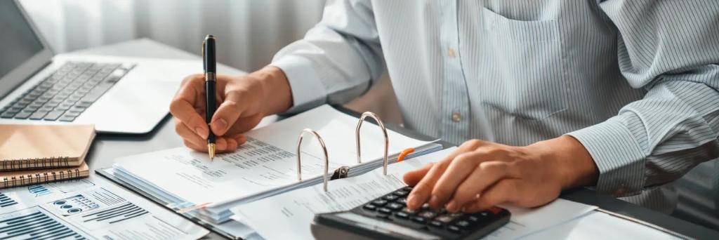 Accountant working at desk with client
